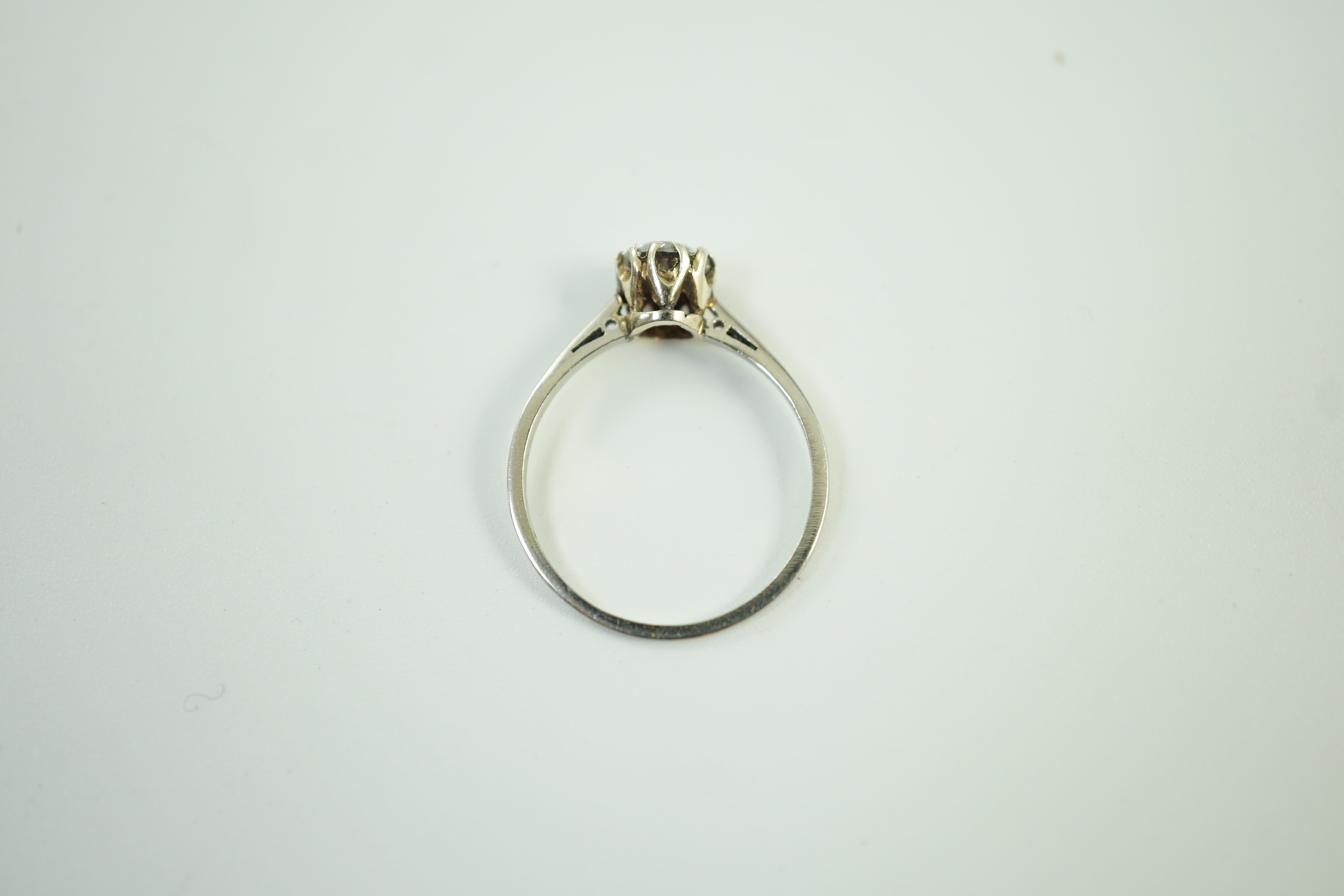 An 18ct and plat set and simulated diamond ring, the stone diameter approx. 4.5mm, size J, gross weight 1.1 grams.